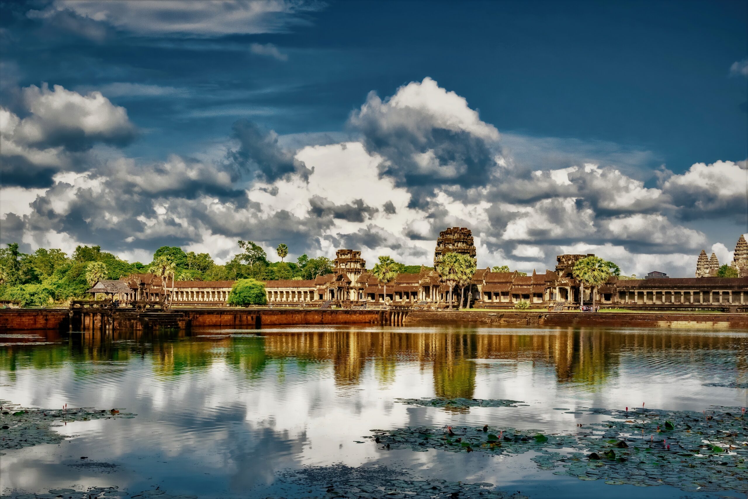The reflection of the clouds in the lake and the Angkor Wat temple of Cambodia in the background