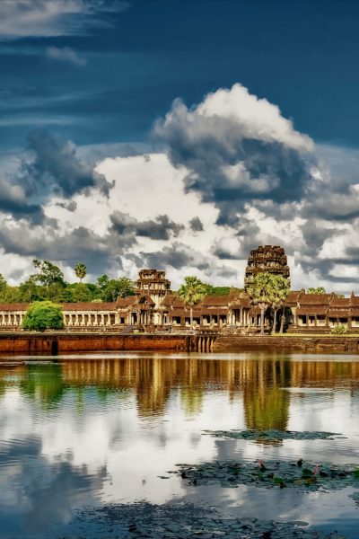 The reflection of the clouds in the lake and the Angkor Wat temple of Cambodia in the background