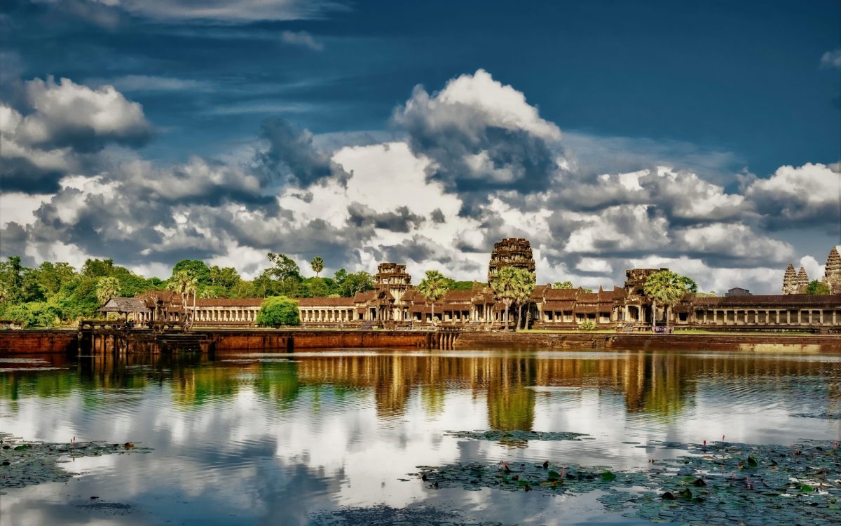 The reflection of the clouds in the lake and the Angkor Wat temple of Cambodia in the background